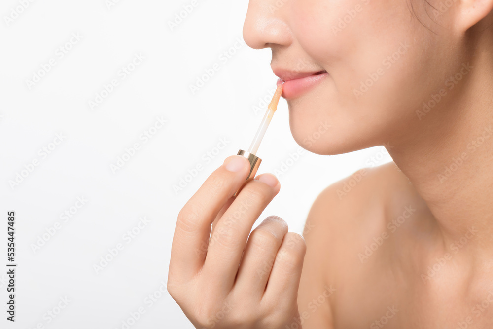 Portrait young asian woman looking mirror applying makeup lipstick at room