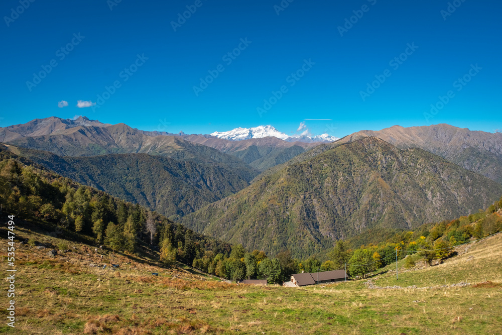 Early fall panorama of the Panoramica Zegna mountains. Is a touristic viewpoint, located in Piedmont Region (Northern Italy), Biella Province. on background: the Rosa Massif (Italian Alps).