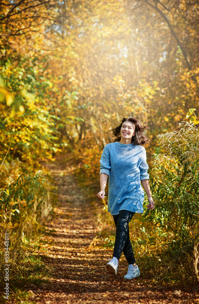 Portrait of stylish happy young gir walking in beautiful yellow forest Portrait of stylish happy young gir walking in beautiful yellow forest