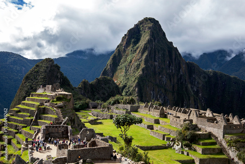 The ancient ruins of Intihuatana (left) and the industrial buildings (right) at Machu Picchu which is a 15th-century Inca site located 2,430m above sea level in the Sacred Valley of the Incas in Peru.