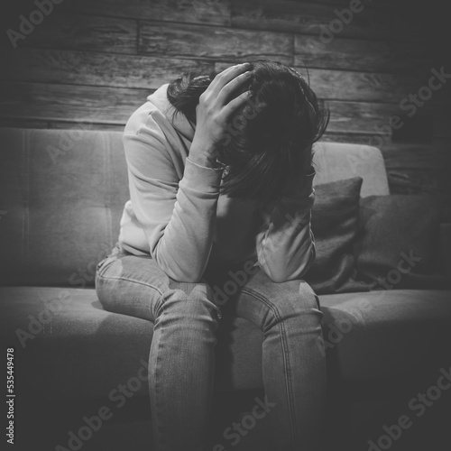 Portrait of girl is grieving. Grief, unhappiness is emotion or moral shock. Depression and mental problems. Black and white photo. © DedMityay