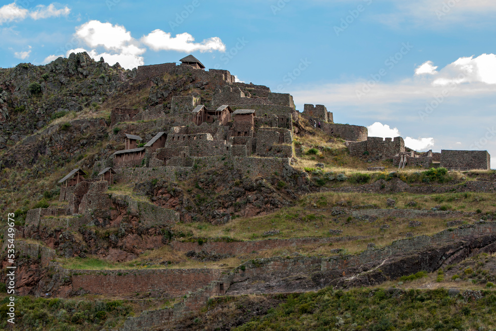The ancient ruins of Pisac in the Sacred Valley of the Incas in Peru. These Incan ruins, known as Inca Písac, lie atop a steep mountain.