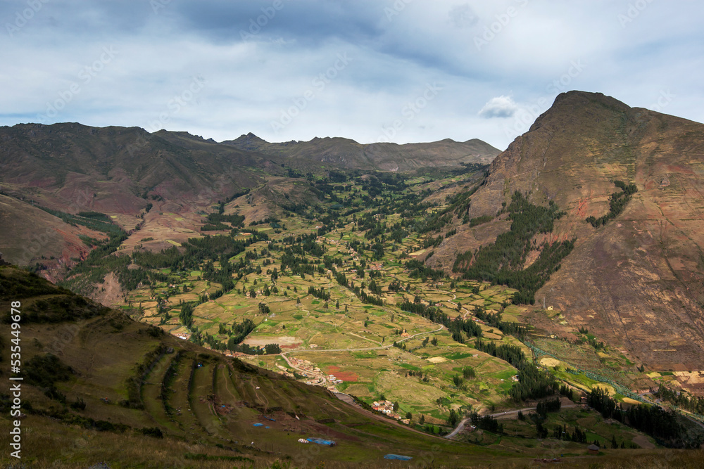 The mountain view including ancient terraces seen from the ruins of Pisac in Peru. The ruins of Pisac are located in the Sacred Valley of the Incas.