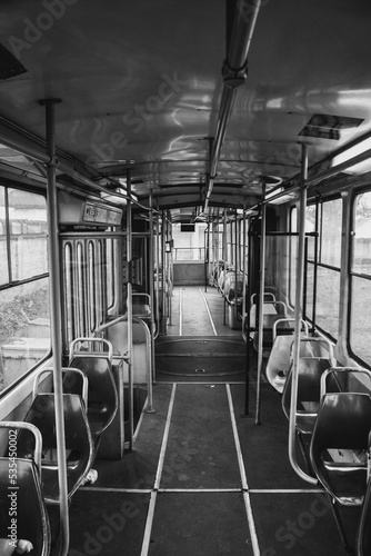 Vertical grayscale of the inside of an empty bus