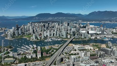 Aerial drone view of the downtown of Vancouver with modern buildings and a port with moored boats
