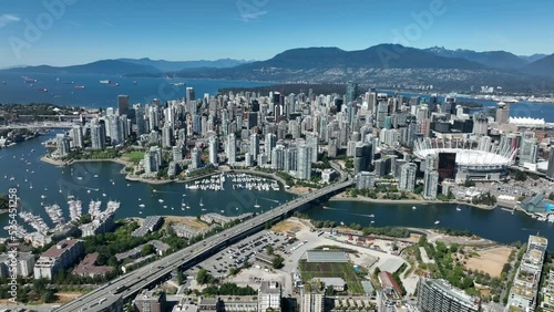 Aerial drone view of the downtown of Vancouver with modern buildings and a port with moored boats photo