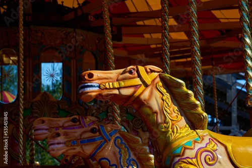 фотографія Closeup of a spinning horse carousel captured in the Dreamland amusement park
