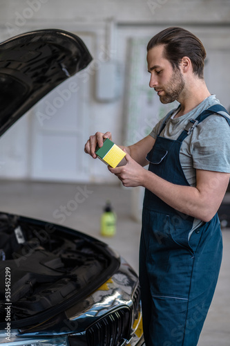 Young mechanic working at the car service station