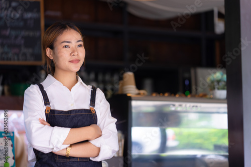 Woman standing in front of coffee shop photo