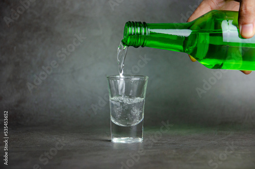 soju is pouring on glass, selective focus