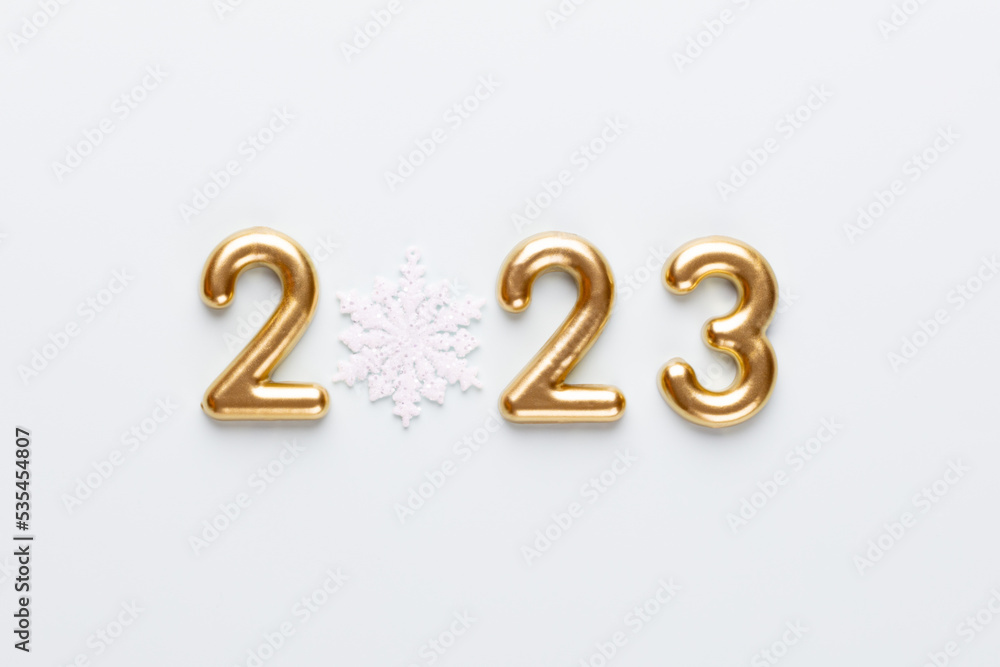 New year 2023 number, golden digits and santa hat over blue background. New year 2023 number, golden digits and santa hat over blue background.