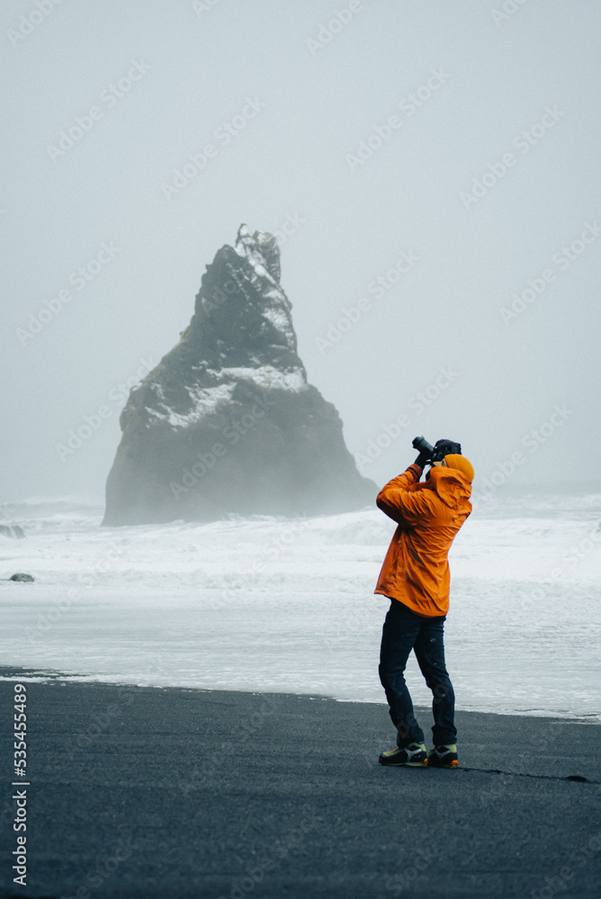 man taking a picture of the landscape of iceland