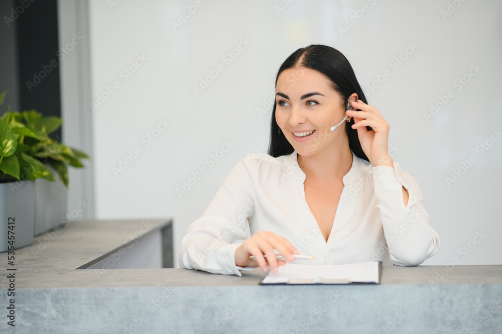 Picture of pretty receptionist at work. Picture of pretty receptionist at work.