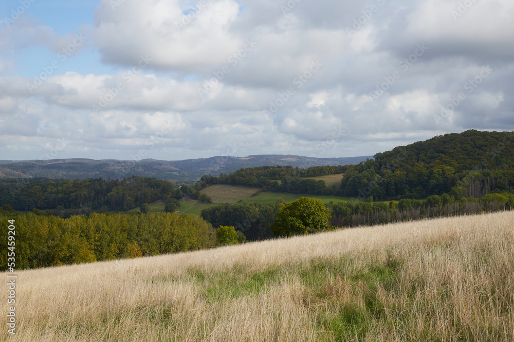 dry meadow with countryside hills in the background dry meadow with countryside hills in the background