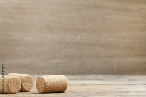 Corks of wine bottles on wooden table. Space for text