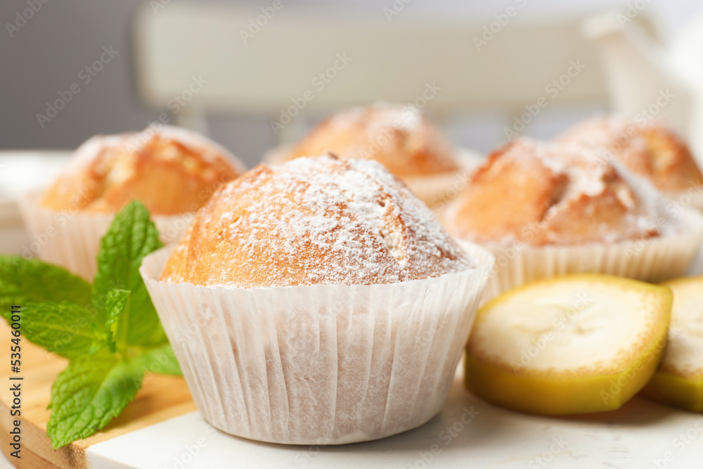 Tasty muffins served with mint and banana on board, closeup Tasty muffins served with mint and banana on board, closeup