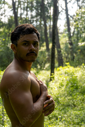 man seen up close, without shirt doing stretches on yoga mat, exercise, latin america