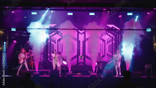 rock gig on stage, modern trendy indie pop or jazz-funk musical band, playing and singing songs