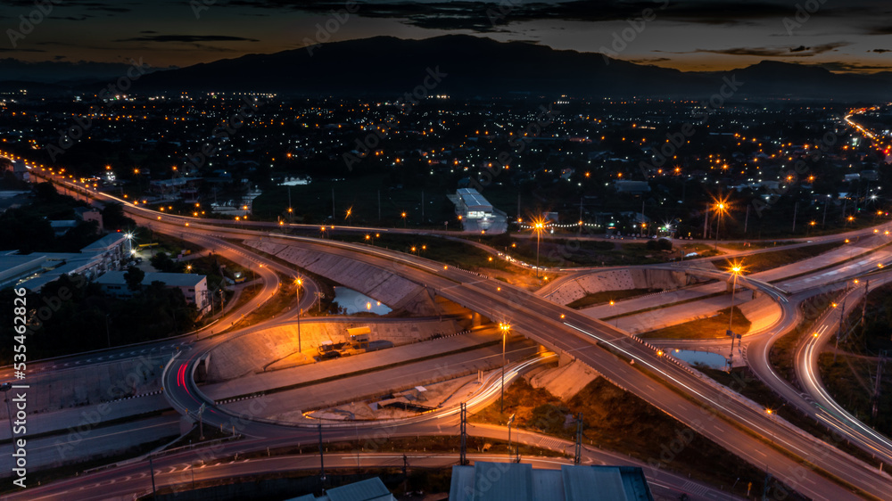 Blur,aerial drone photo of ring road, multilevel circular junction road, road junction. Aerial view of the transportation, traffic, route road at night in the city of Thailand. Blur,aerial drone photo of ring road, multilevel circular junction road, road junction. Aerial view of the transportation, traffic, route road at night in the city of Thailand.