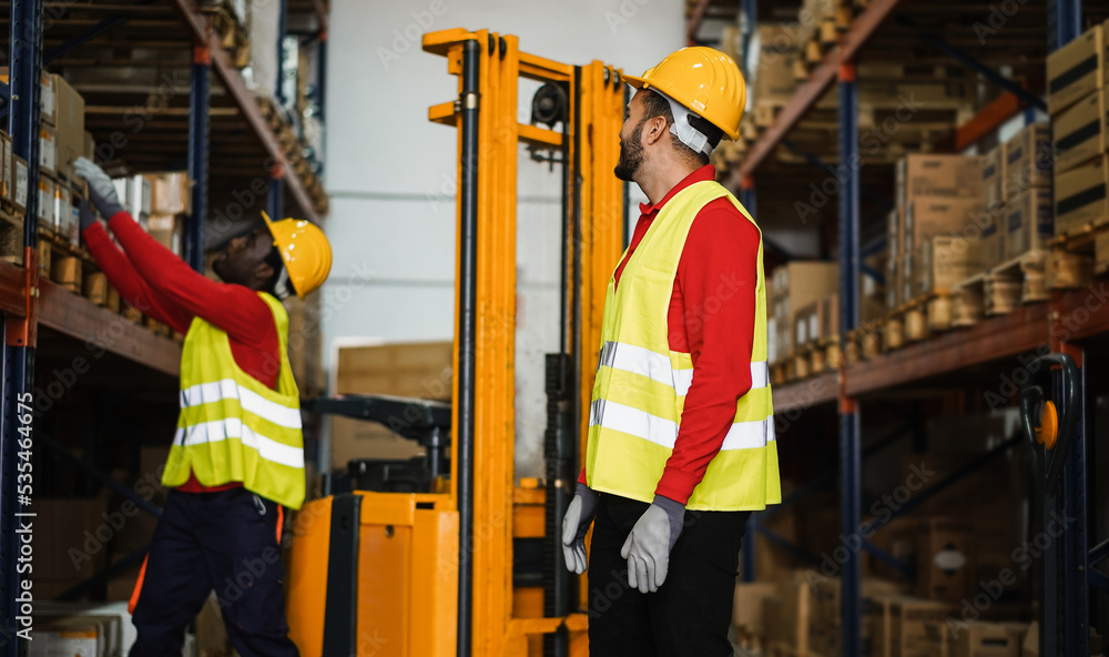 Photography Industrial workers loading delivery box inside warehouse store - Focus on right