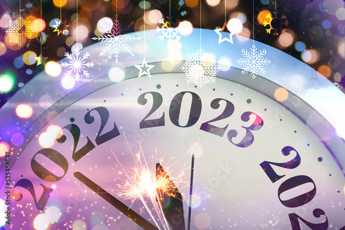 Festive collage of clock and blurred lights on dark background  closeup. New Year celebration