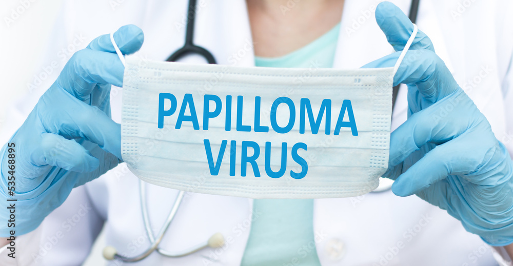 Papiloma Virus inscription on a blue protective face mask in the hands of a doctor Papiloma Virus inscription on a blue protective face mask in the hands of a doctor