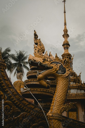 Vertical shot of the Dragon Boat installation at Kiri Dragon Boat Temple in Tumpat, Malaysia photo