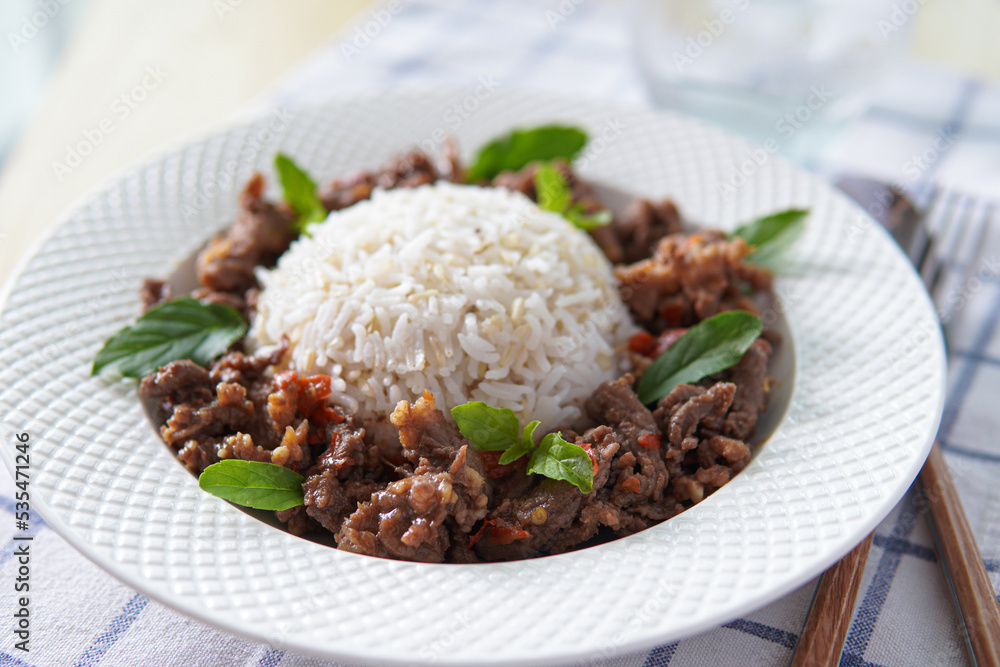 Thai food stir-fried beef spicy and basil served with brown rice Thai food stir-fried beef spicy and basil served with brown rice