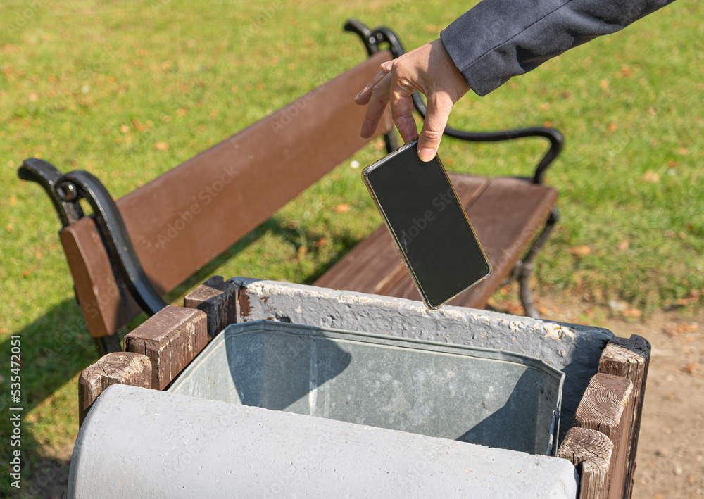 Hand Throws out Smartphone Garbage, Throwing Smartphone into Street
