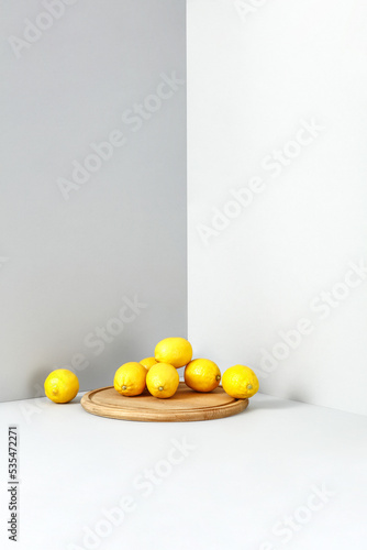 Fresh yellow lemon fruits and gray wall background. 