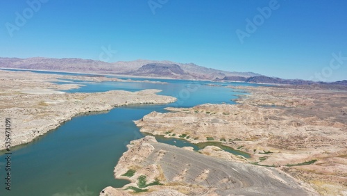 High-angle shot of a part of lake Meade with sandy area around and sky background photo