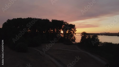 Drone soaring through the trees at sunset. High quality 4k footage