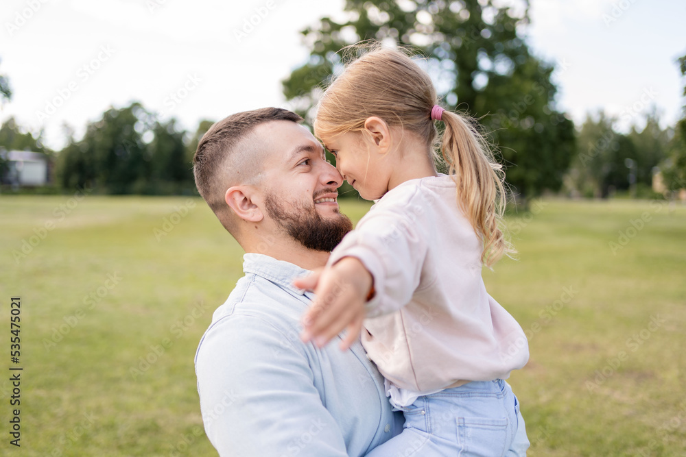 young father carrying daughter having fun enjoying time together outdoors in park. young father carrying daughter having fun enjoying time together outdoors in park.