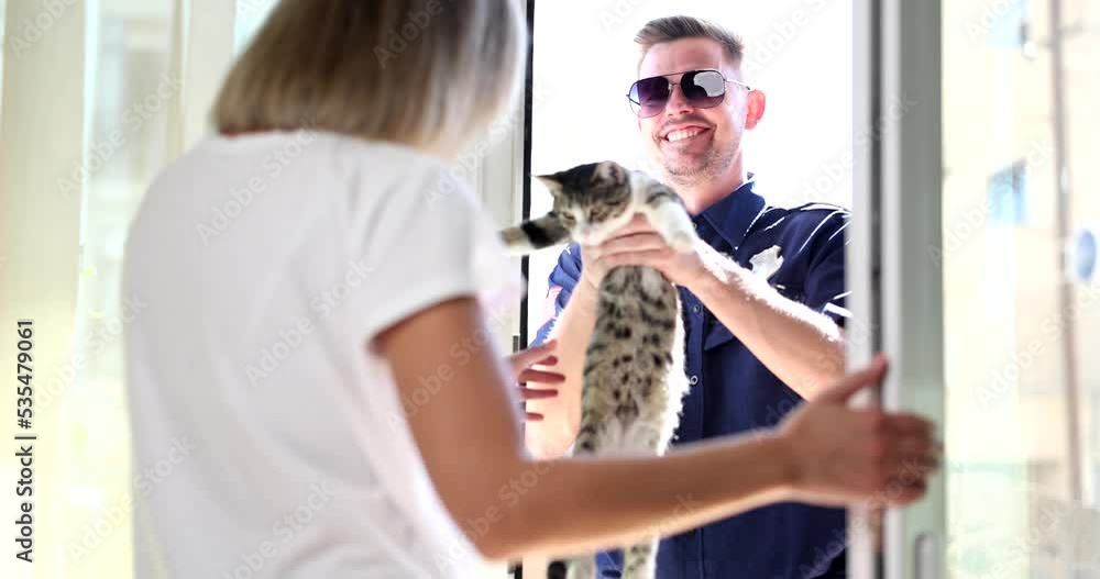 Policeman giving missing kitten to woman at home 4k movie slow motion Policeman giving missing kitten to woman at home 4k movie slow motion