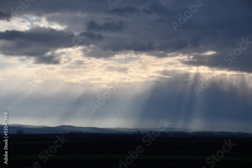 Sun rays from cloudy sky  over mountain