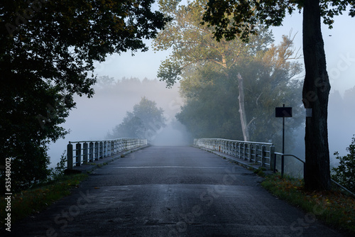 FOG - Mist on the bridge over the river photo