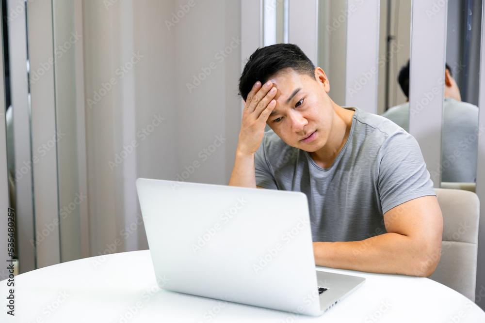 Tired young man working at home has a headache after a long hard day at work Tired young man working at home has a headache after a long hard day at work