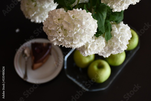 White flowers, cake and apples 
