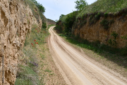 Dusty road through hills 