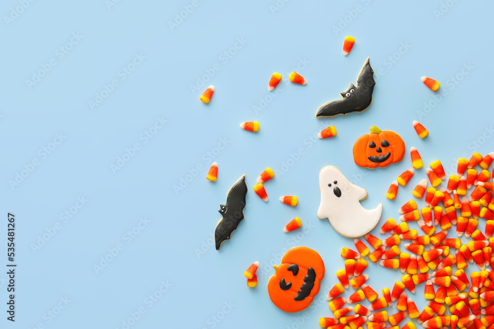 Halloween candy corns and cookies on blue background Halloween candy corns and cookies on blue background