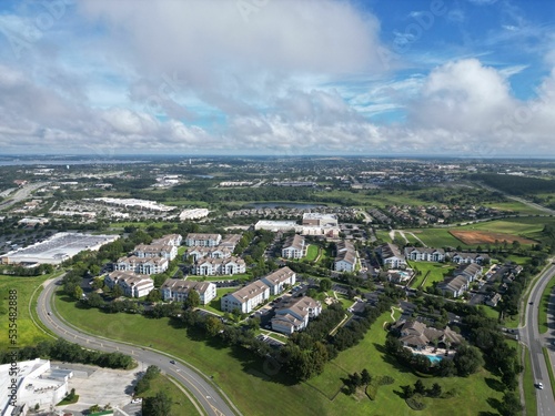 Bird's eye view of the cityscape of Clermont, Florida under a cloudy blue sky