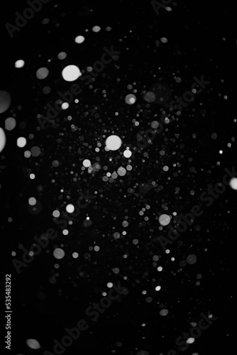 Snow background. Snow on a black background. Snowflakes for overlay.