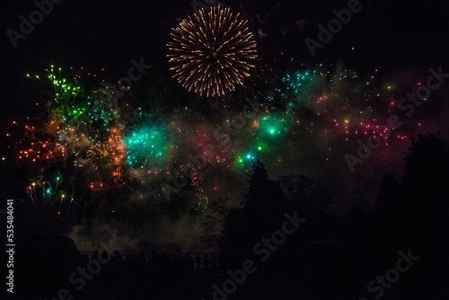 Silhouette of trees on the fireworks show in Alton Towers theme park photo
