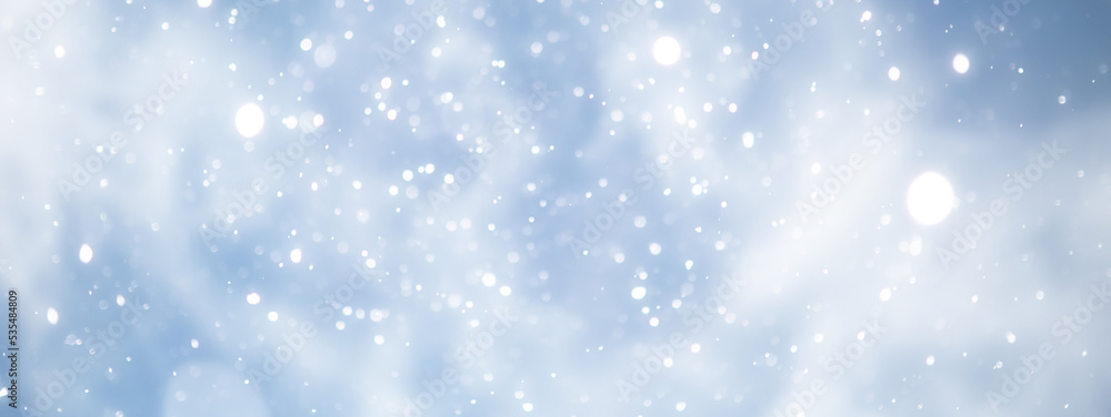 Fototapeta premium blue snowfall bokeh background, abstract snowflake background on blurred abstract blue