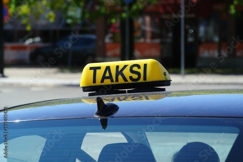 'taksi' sign on roof of car photo