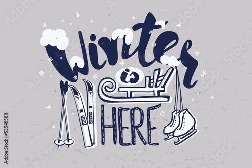 Lettering handrawing text winter is here. Phrase decor with snowflakes, skis, sled and skates.  For season banner sale, gift card, emotion card.  photo