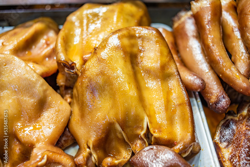 Braised pig ears on a food street braised pork stall photo