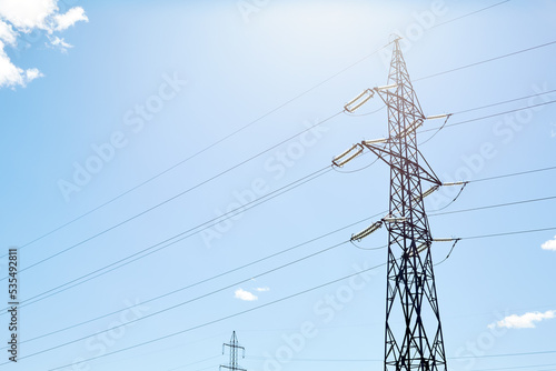 Electric pole with wires under the blue sky