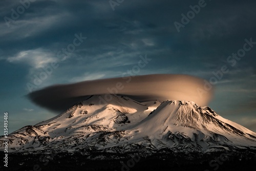 Shasta view with a brown volcano cloud on the top and a gloomy sky background photo