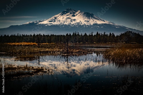 Gifford Pinchot national forest view lake with shallows reflecting a snowy mountain, sky background photo